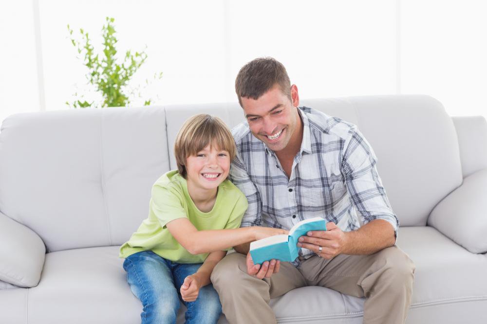 Father-and-son-with-story-book-sitting-on-sofa_png_85